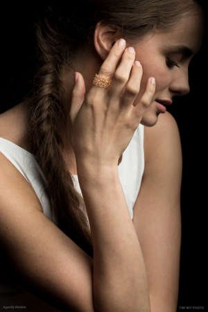 woman hand. woman hands and face. fashion accessories ring on finger woman fashion portrait on black background.の写真素材
