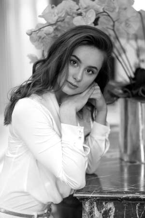 Business portrait of a woman in a blue office dress on white background. Business profile photo of happy confident woman looking into the camera.の写真素材