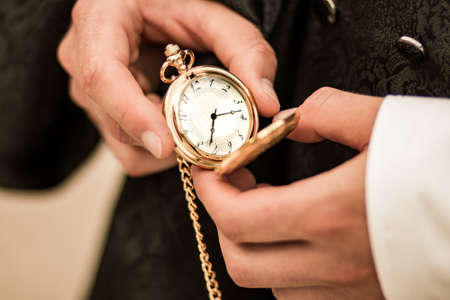 pocket watch in hands holding old clockの写真素材