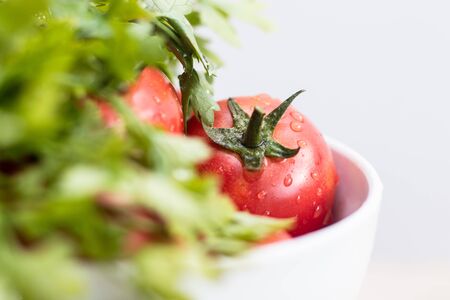 Fresh tomatos and herbs on wooden background. Summer salad. Summer backgroundの写真素材