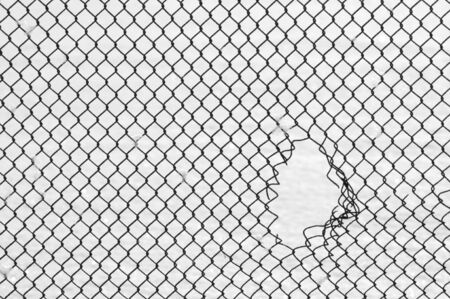 The hole in the steel mesh の写真素材