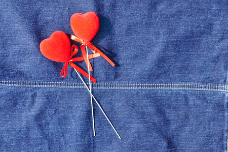 Hearts on the background of blue jeans の写真素材