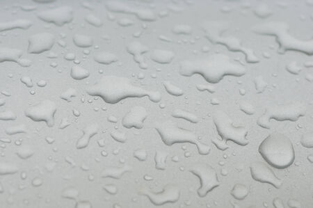 Drops of different shapes on a gray background.の写真素材