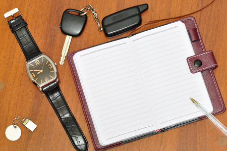 Notebook, watch and car keys.の写真素材