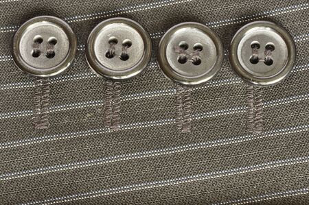 Four buttons on the fabric.