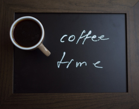 Coffee time note and cup of coffeeの写真素材