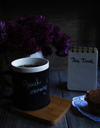 Autumnal table setting with bunch of autumn flowers and cup ofの写真素材