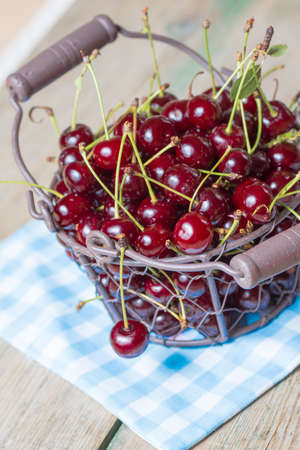large and juicy ripe cherries in a basket, fresh fruitsの写真素材