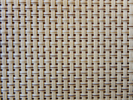 close-up of a beige fabric plastic lattice, grid texture; pattern of horizontal and vertical interwoven lines may be used as a backgroundの写真素材