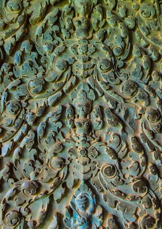 An old ornament on the ancient wall with moss, Angkor Wat, Cambodiaの写真素材