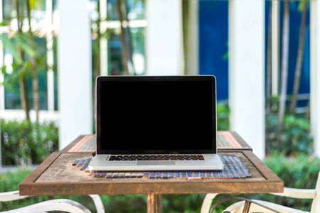 laptop, cup and diary on tableの写真素材