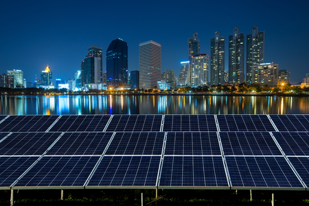 Solar panel with city night light background.の写真素材