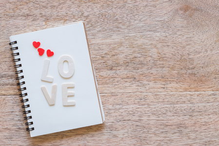 Valentine's day love Letter with notebook on wooden board background with copy space.の写真素材