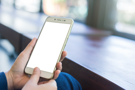 female use cell phones blurred images in coffee shop like the background.の写真素材