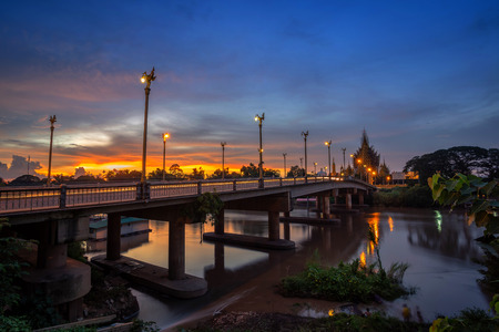 Beautiful of sunset at the Bridge over the Nan River in Phitsanulok City, Thailand.の写真素材