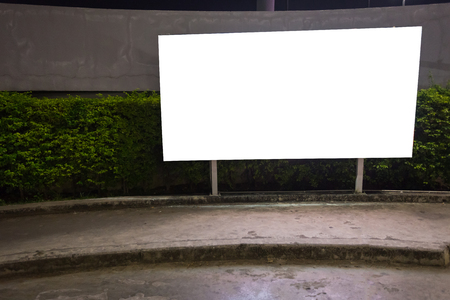 White blank billboard ready for new advertisement,lightbox mounted on the wall of store street in a city at night.の写真素材