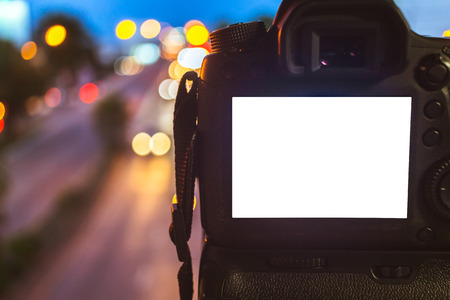 Close-up of DSLR Camera capturing on colorful light abstract circular bokeh background,Night time,Mockup image of with blank screen,DSLR on Tripod.の写真素材