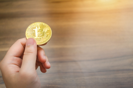 Handle of Bitcoin coin on wooden floor background.の写真素材