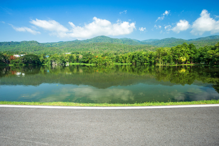 Along road landscape view in Ang Kaew Chiang Mai University Forested Mountain blue sky background with white clouds, Nature Road in mountain forest.の写真素材