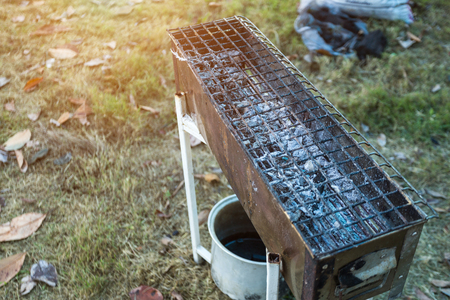 Close up charcoal stove with fire made of steel,stick on stove charcoal on Campsite in the forest.の写真素材