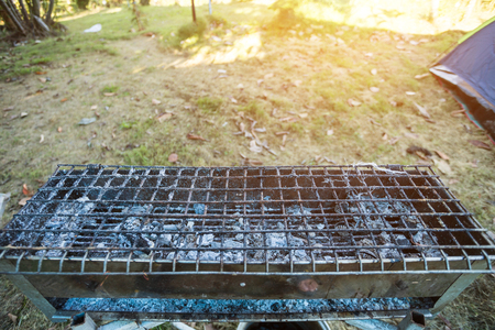 Close up charcoal stove with fire made of steel,stick on stove charcoal on Campsite in the forest.の写真素材