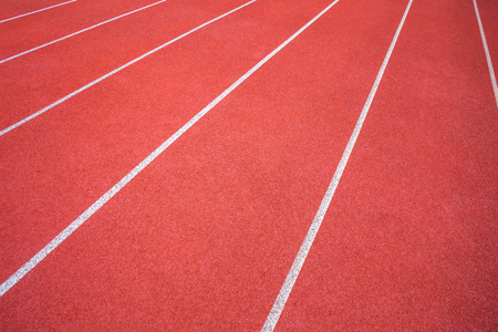 White lines of stadium and texture of running racetrack red rubber racetracks in outdoor stadium are 8 track and green grass field,empty athletics stadium with track.の写真素材