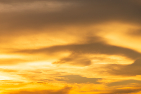 Orange sky background texture with white clouds sunsetの写真素材