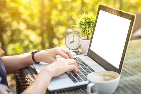 Close-up of Business female working with laptop, coffee, clock, smart phone, and notebook on office outdoorの写真素材