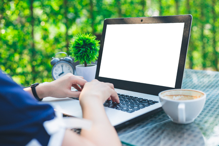Close-up of Business female working with laptop, coffee, clock, smart phone, and notebook on office outdoorの写真素材