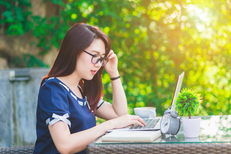 Asian business female working with laptop on office outdoor,Think about the jobの写真素材