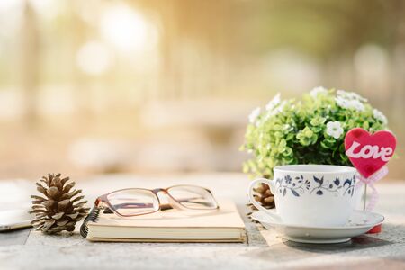 Close-up of empty notebook,spectacles and cup of coffee on Marble floor background. Love concept with heart desktop,Valentine's Day.の写真素材