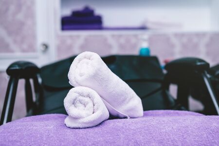 Turquoise spa towels pile on armchairs with washing stands in hairdressing salon.の写真素材