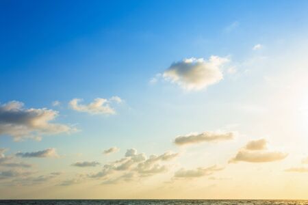 Beautiful early morning sunrise over the sea the horizon,blue sky background texture with white clouds sunset.の写真素材