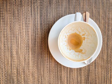 Empty coffee cup on wood desk on top view. As breakfastの写真素材