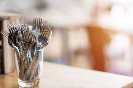 Many fork are placed with In the glass on the dining table decoration in hotelの写真素材