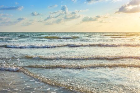 Beautiful Sunset over and Wave of the sea on the sand beach the horizon at Hat chao lao beach in Chanthaburi Thailand.の写真素材