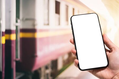Close-up of female use Hand holding smartphone blurred images touch of Abstract blur of defocused in train station the background.の写真素材