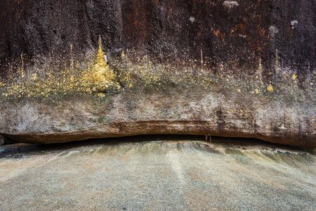 People traveling Gold Foil stick to worship The stone with the footprint of Lord Buddha at Khitchakut mountain It is a major tourist attraction Chanthaburi, Thailand.の写真素材