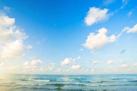 Beautiful early morning sunrise over the sea the horizon,blue sky background texture with white clouds sunset.の写真素材