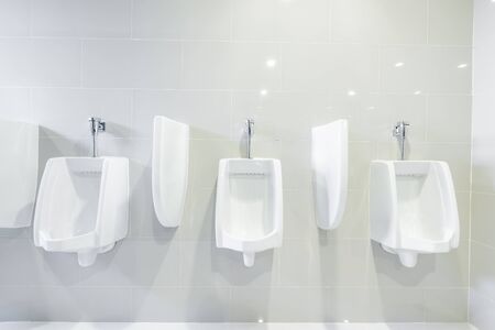 public toilet urinals lined up, no privacy.の写真素材