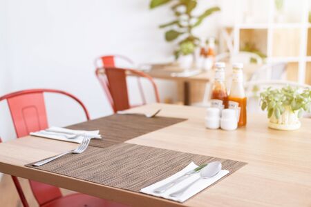 Close-up of luxurious spoon and fork, flower vaseson, sauce bottle the dining table decoration in hotelの写真素材