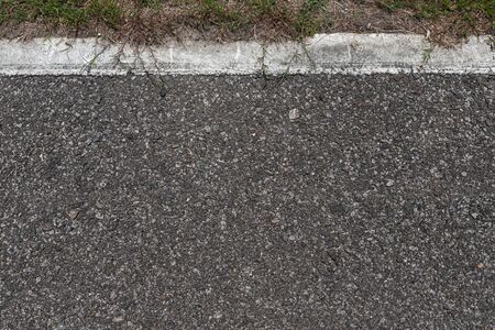 Asphalt road with stripes and green grass texture Background,empty copy space.の写真素材