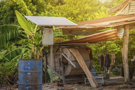 Solar panel in a rural houses area and old oil barrels are ready to recycle Industrial, Agro-industry of household Rural style in Thailand, Alternative energy conceptの写真素材