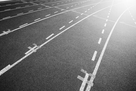 White lines of stadium and texture of running racetrack black rubber racetracks in outdoor stadium...