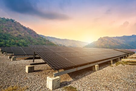 solar panels with against view of the reservoir and mountanis landscape against during sky...