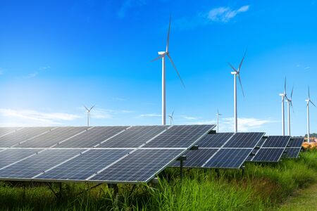 Photovoltaic modules solar power plant with wind turbines against and blue sky with clouds,Alternative energy concept.の写真素材