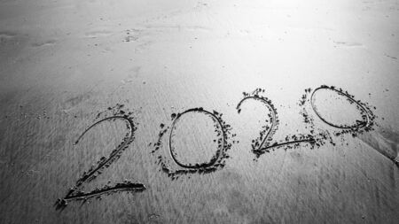 Black and white of Happy New Year 2020 text on beautiful the sea beach with wave early morning sunrise over the horizon background.During Christmas and New Year.の写真素材