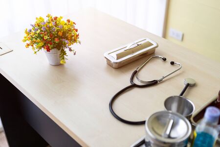 Stethoscope,vial,syringe and medical bottle different drugs on surgical tray with medical equipment on wooden table backgroundの写真素材