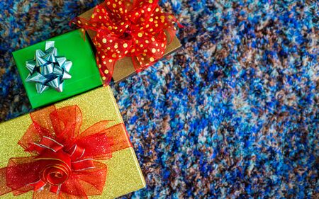 Christmas many gifts on blue carpet interior of top view with Background with Copy Space,Decoration During Christmas and New Year.の写真素材