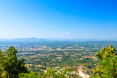 Beautiful panoramic view green forest mountain range Phu Thok Park in Loei province,Thailand, blue sky background texture with white cloudsの写真素材